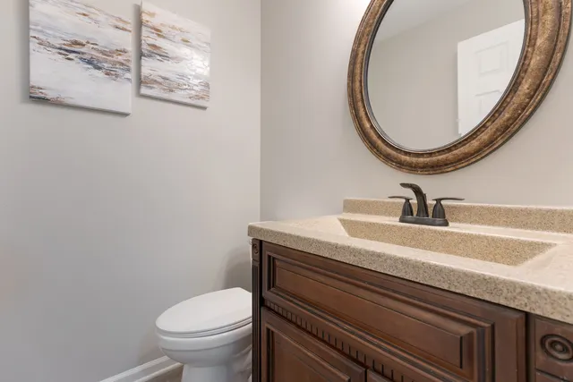 a bathroom with a sink a mirror and toilet