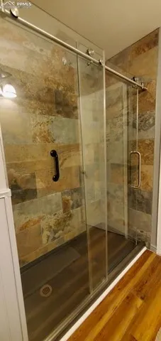 a bathroom with a shower and vanity