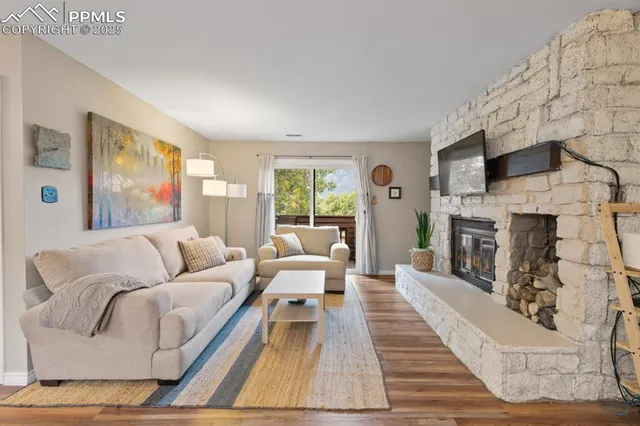 a living room with furniture and a fireplace