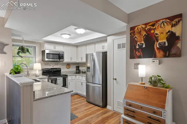 a kitchen with stainless steel appliances granite countertop a refrigerator stove and sink