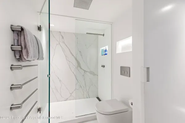 a bathroom with a shower toilet and sink