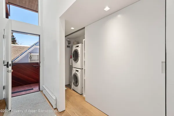 a view of a hallway with washer and dryer