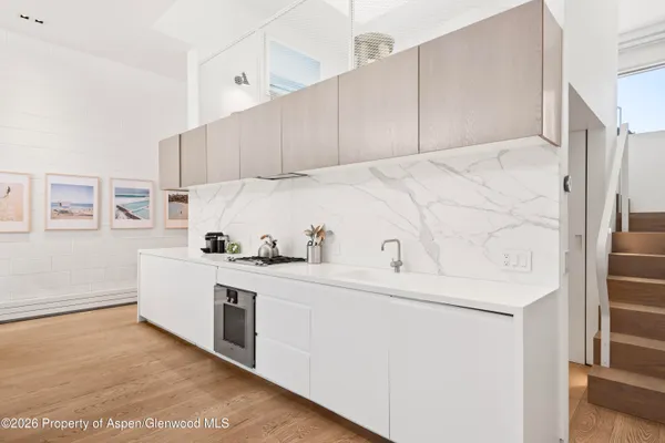 a kitchen with cabinets and white appliances