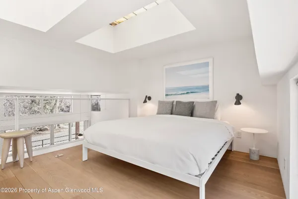 a bedroom with a bed and a night stand