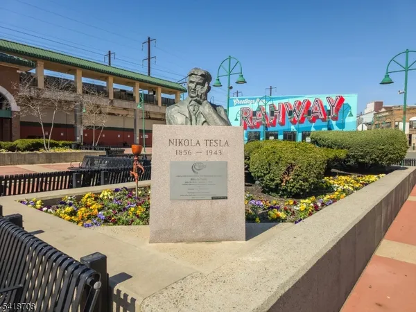 a view of a street with wooden fence