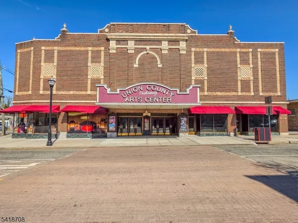 a front view of multi story building with retail shop