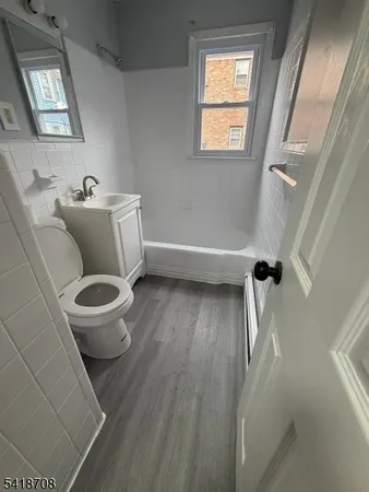 a bathroom with a granite countertop toilet a sink and a mirror