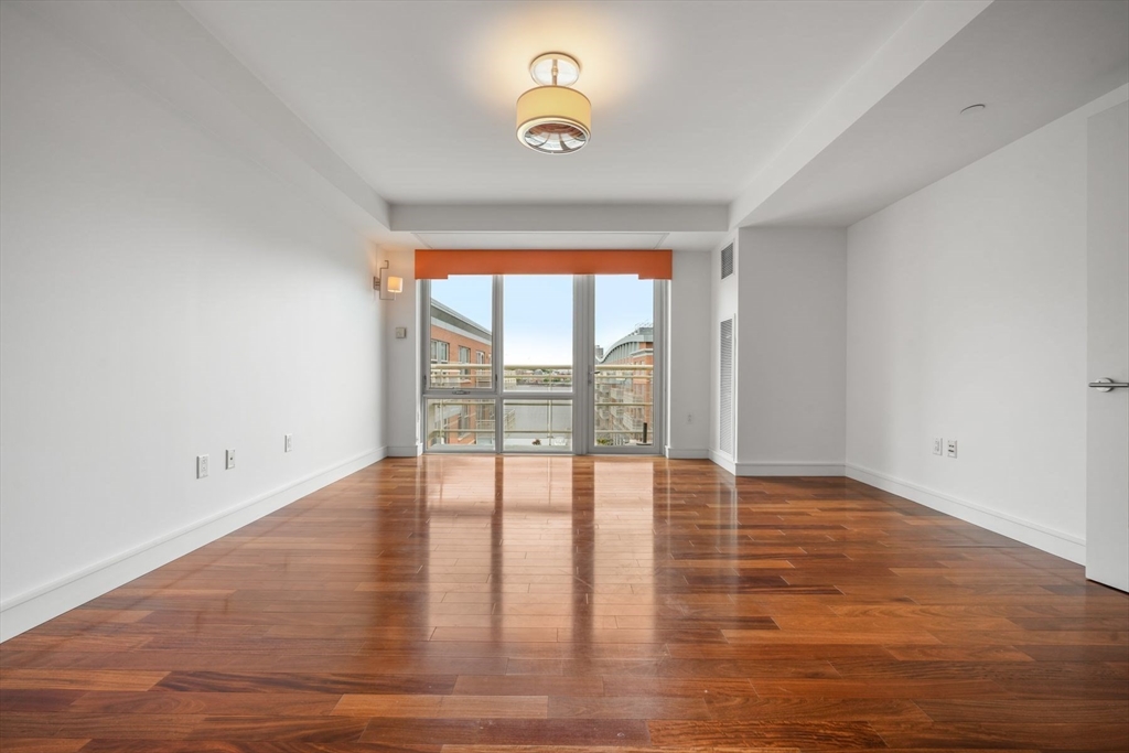 2 Battery Wharf, Unit 2504 Boston, MA 02109 - Photo 12 of 22 a view of an empty room with wooden floor and a window