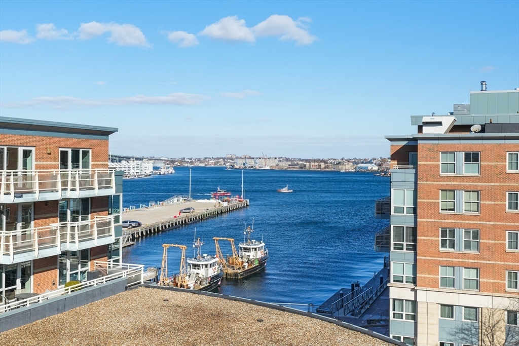 2 Battery Wharf, Unit 2504 Boston, MA 02109 - Photo 14 of 22 a view of roof deck with a barbeque and wooden stairs