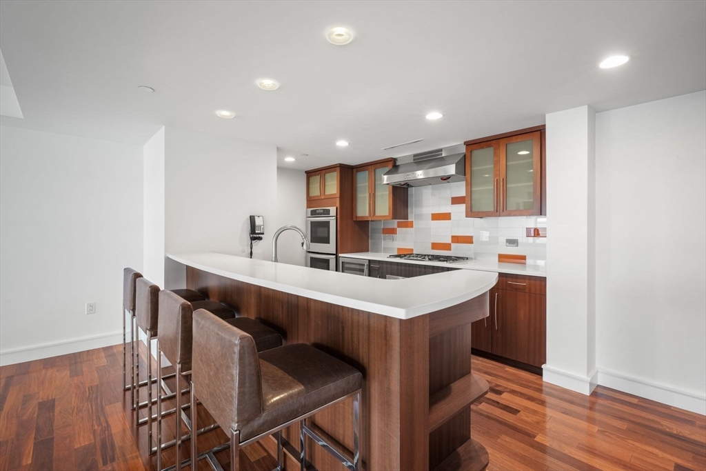 2 Battery Wharf, Unit 2504 Boston, MA 02109 - Photo 9 of 22 a kitchen with stainless steel appliances a sink stove and cabinets