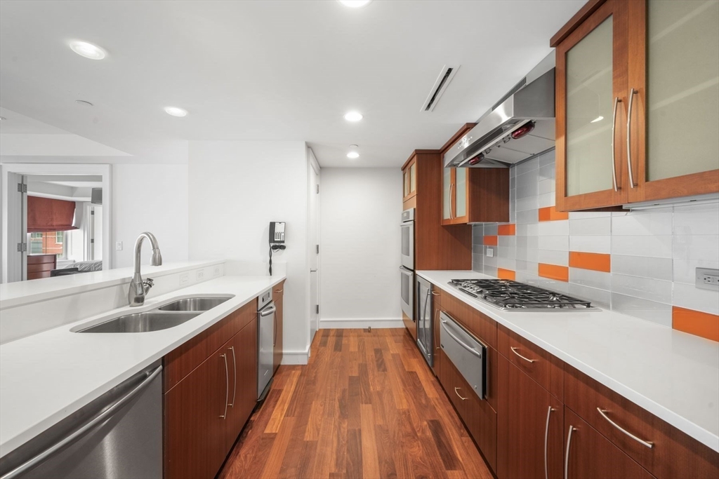 2 Battery Wharf, Unit 2504 Boston, MA 02109 - Photo 10 of 22 a kitchen with stainless steel appliances granite countertop sink stove and cabinets