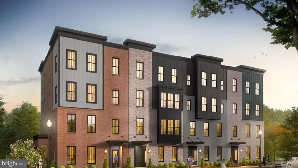 a front view of a residential apartment building with a yard