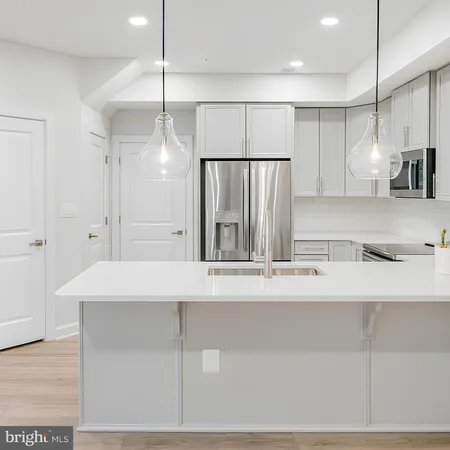 a large white kitchen with a sink