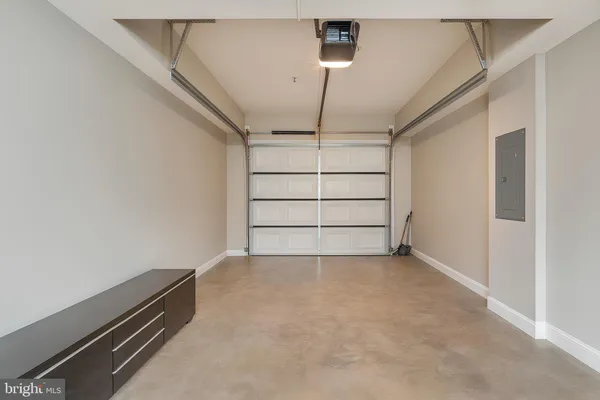 an empty room with stairs and wooden floor