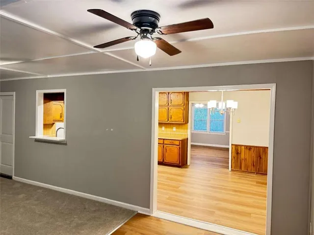 a view of dining room with a sink and wooden floor