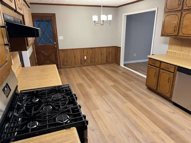 a room with wooden floor and furniture