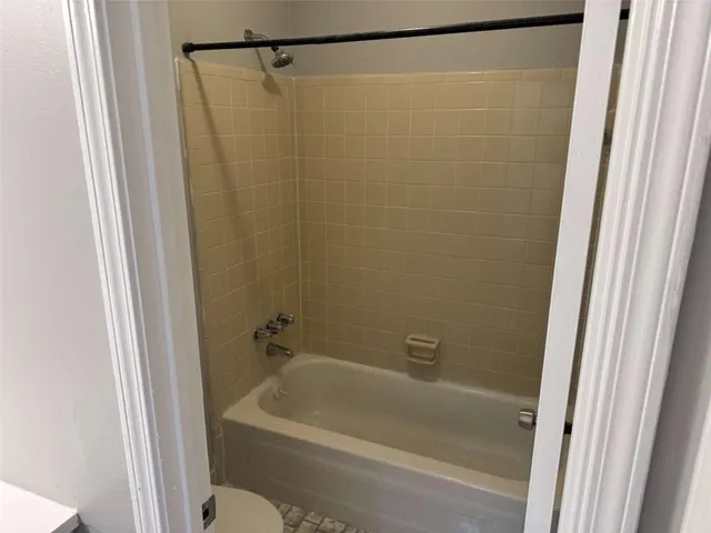 a bathroom with a shower and a sink