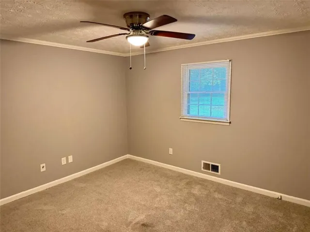 an empty room with a fan