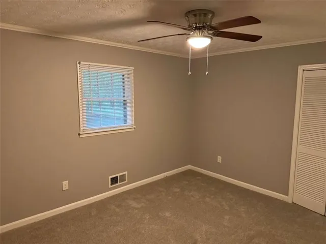 a view of an empty room with a fan