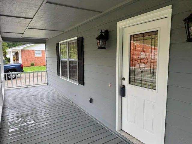a view of a porch of a house with wooden floor