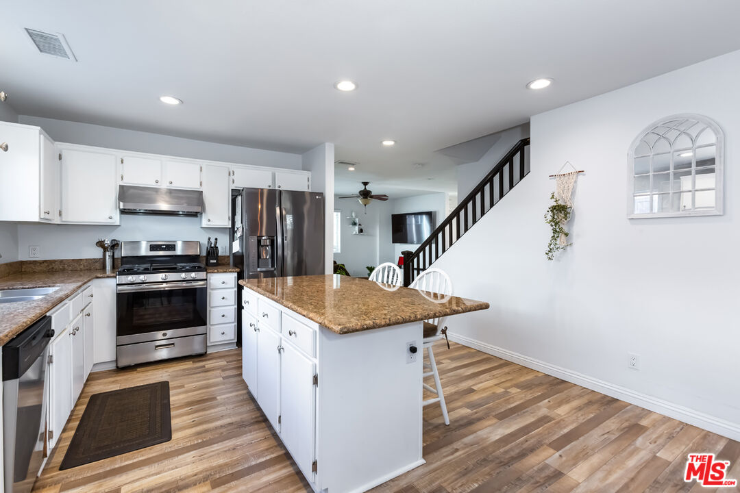 12248 Willowbend Lane Sylmar, CA 91342 - Photo 13 of 52 a kitchen with a stove a sink and a refrigerator