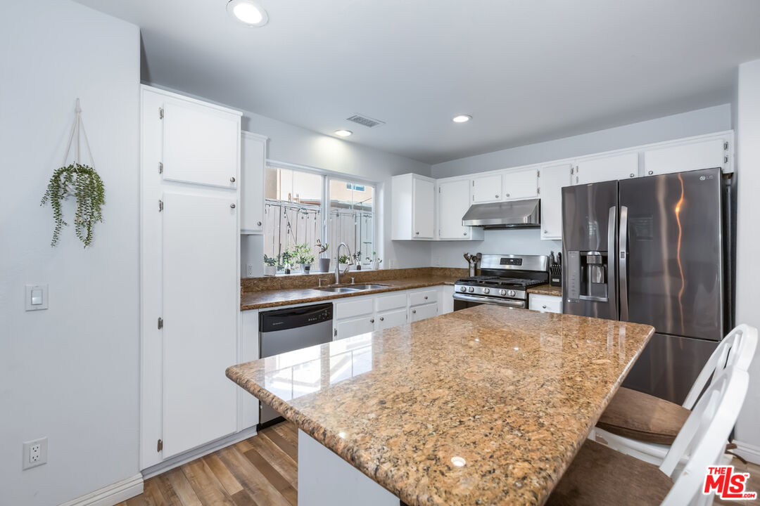 12248 Willowbend Lane Sylmar, CA 91342 - Photo 14 of 52 a kitchen with stainless steel appliances granite countertop a refrigerator sink stove microwave and cabinets