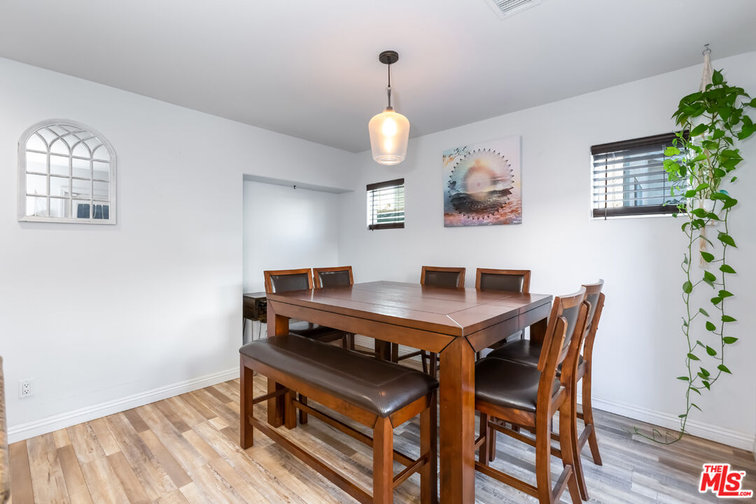 12248 Willowbend Lane Sylmar, CA 91342 - Photo 17 of 52 a view of a dining room with furniture and wooden floor