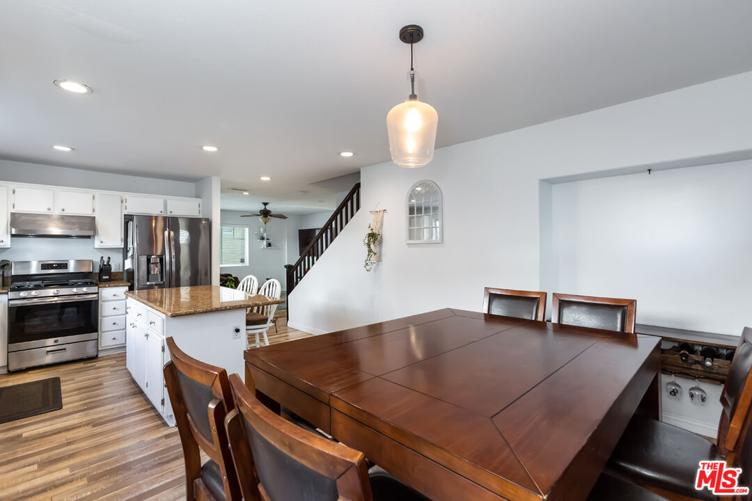 12248 Willowbend Lane Sylmar, CA 91342 - Photo 18 of 52 an open kitchen with a table and chairs in it