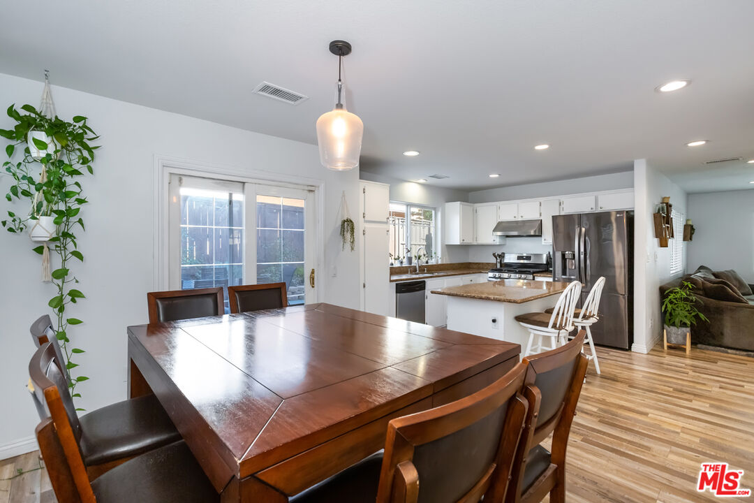 12248 Willowbend Lane Sylmar, CA 91342 - Photo 20 of 52 a dining room with furniture and wooden floor