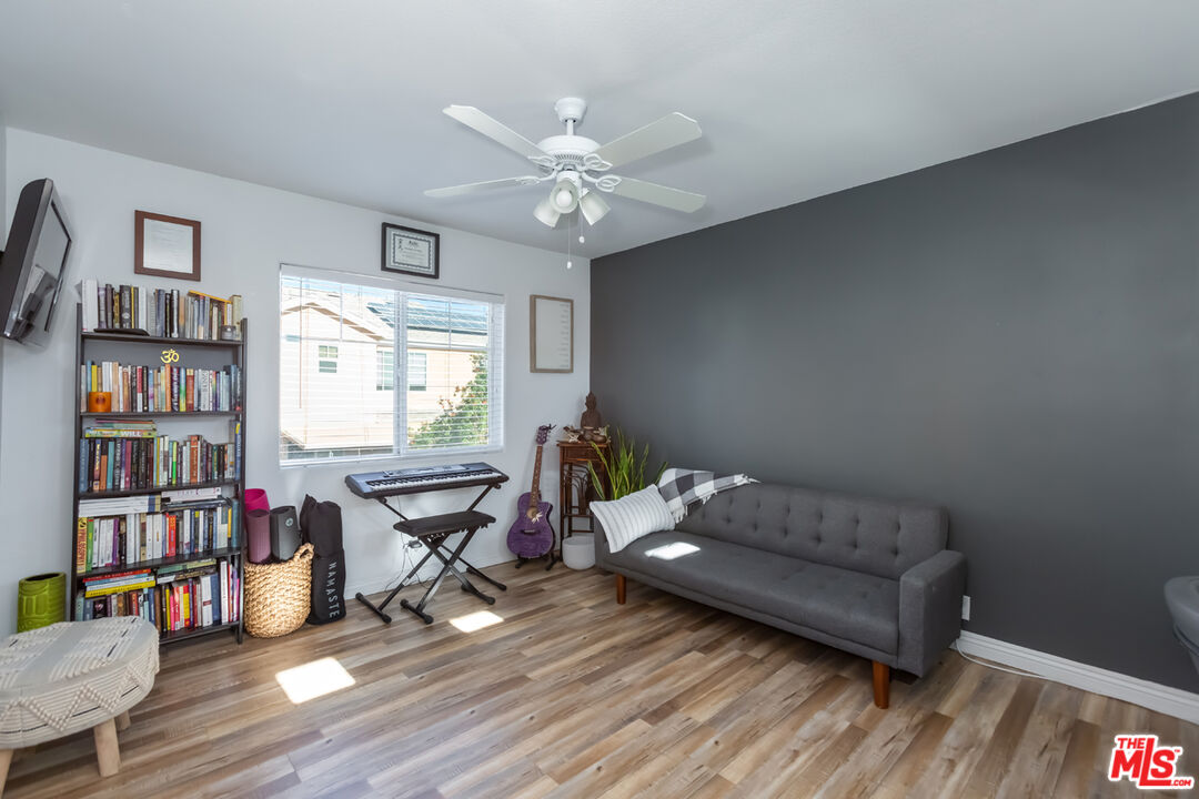 12248 Willowbend Lane Sylmar, CA 91342 - Photo 32 of 52 a living room with furniture a bookshelf and a window