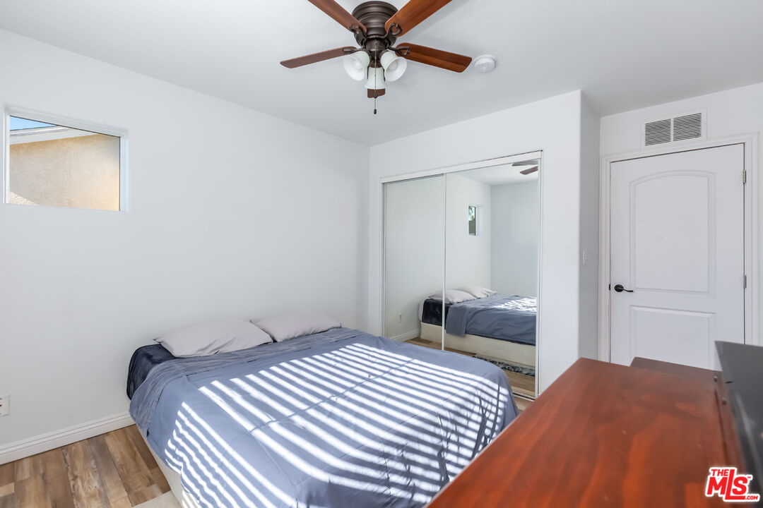 12248 Willowbend Lane Sylmar, CA 91342 - Photo 35 of 52 a bedroom with a bed and a chandelier