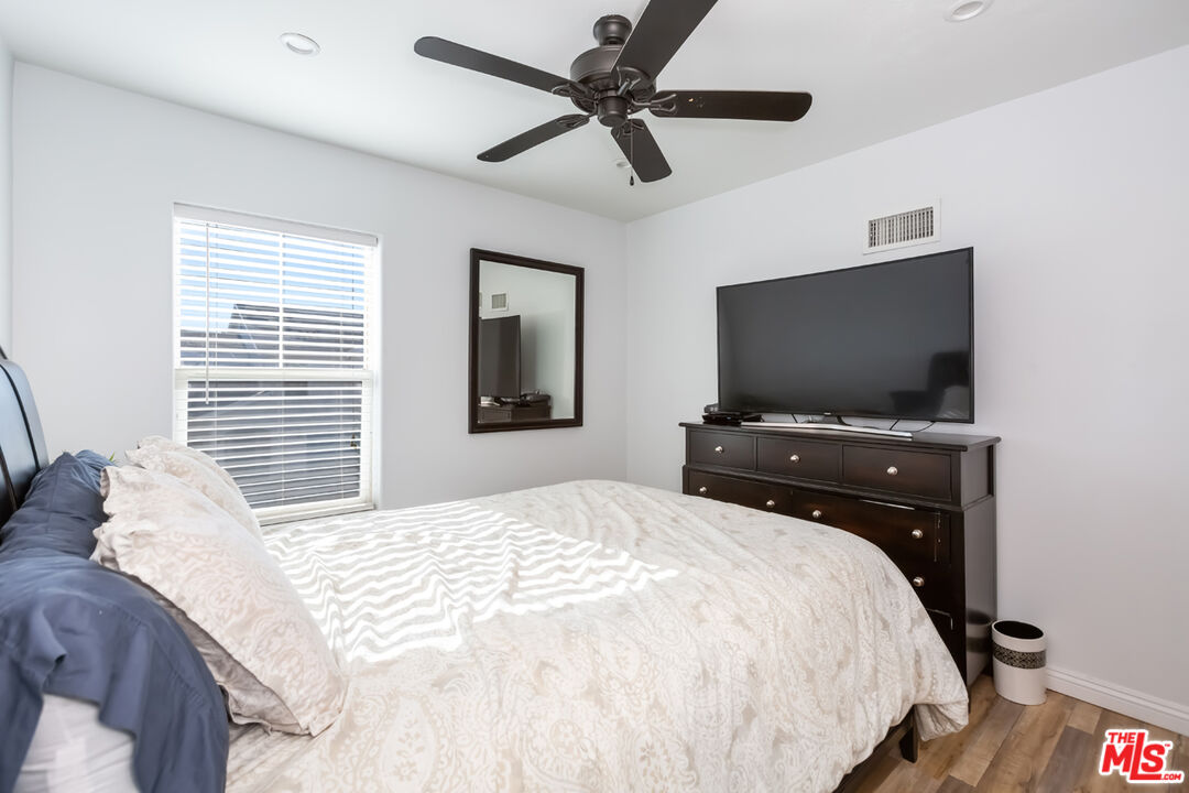 12248 Willowbend Lane Sylmar, CA 91342 - Photo 38 of 52 a bedroom with a bed and a flat screen tv