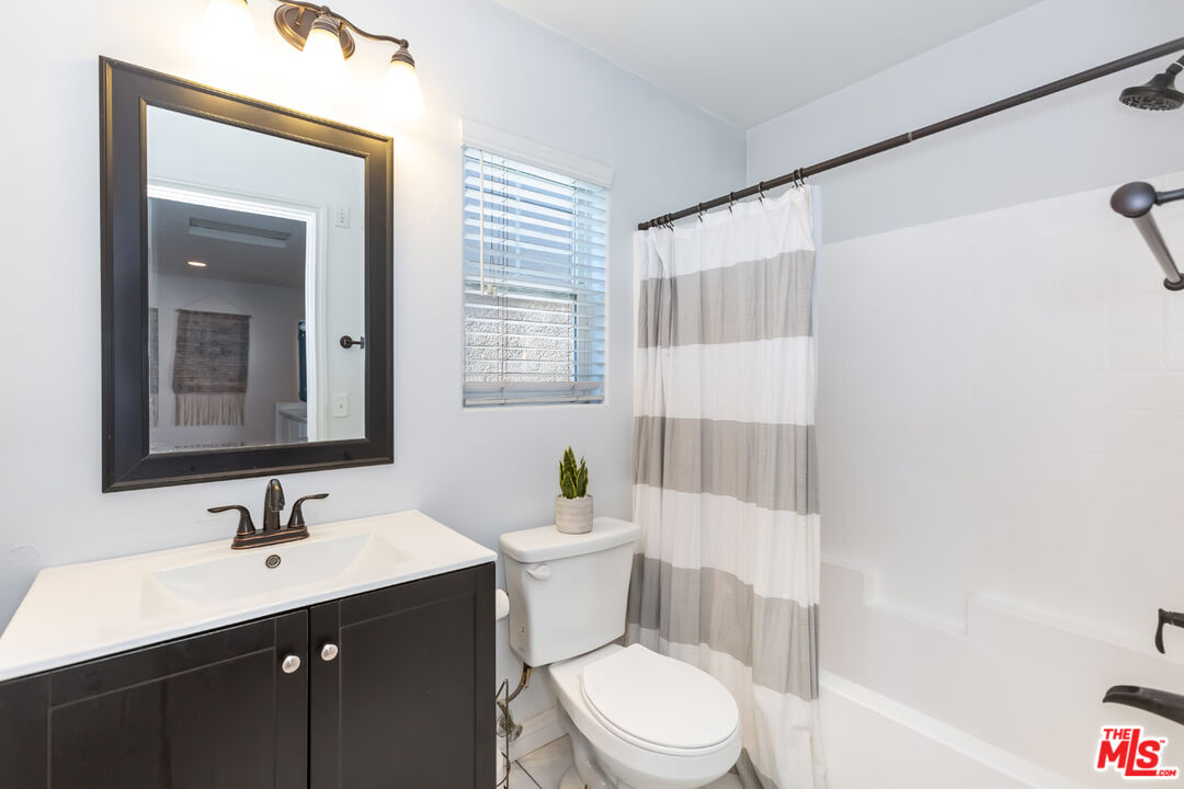 12248 Willowbend Lane Sylmar, CA 91342 - Photo 39 of 52 a bathroom with a sink a toilet and shower