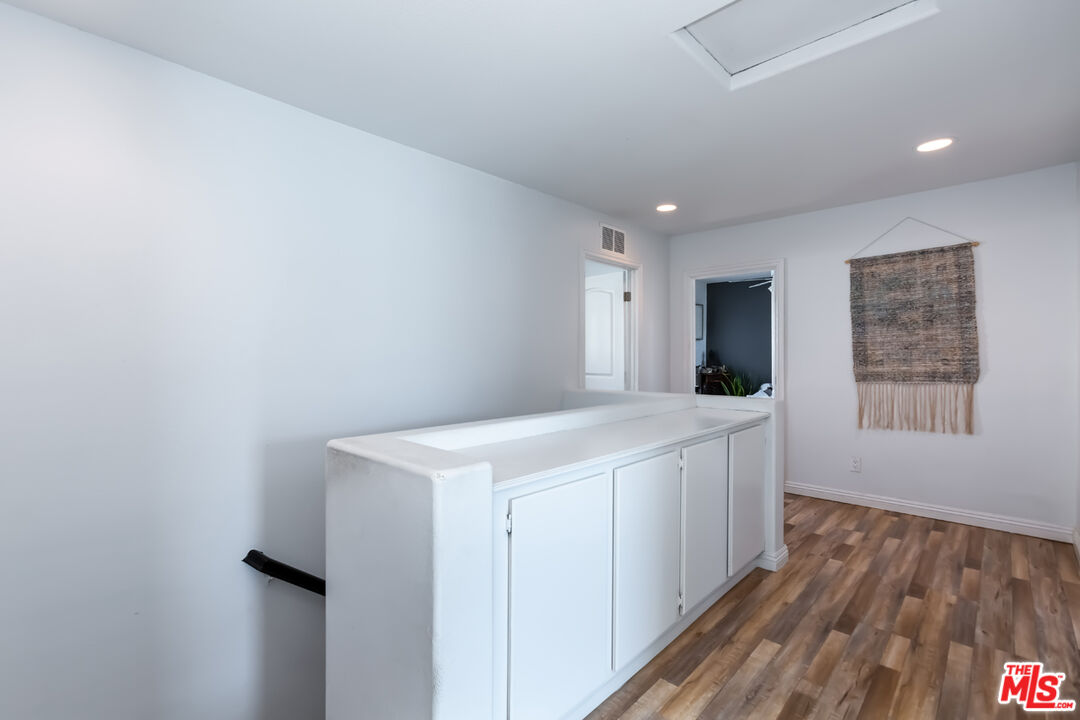 12248 Willowbend Lane Sylmar, CA 91342 - Photo 40 of 52 a view of an empty room with wooden floor and a window