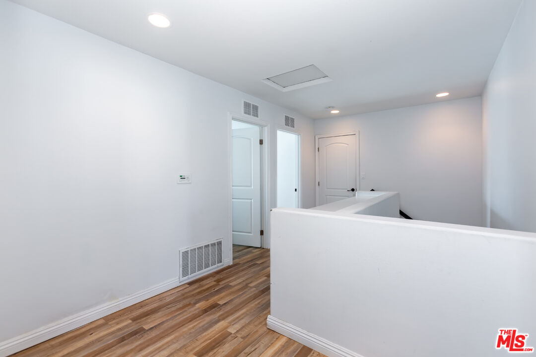 12248 Willowbend Lane Sylmar, CA 91342 - Photo 42 of 52 a view of a hallway with wooden floor