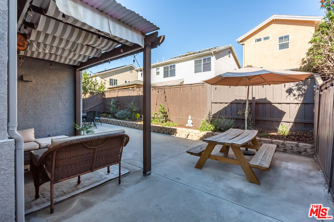 12248 Willowbend Lane Sylmar, CA 91342 - Photo 43 of 52 a view of a patio with a table and chairs under an umbrella
