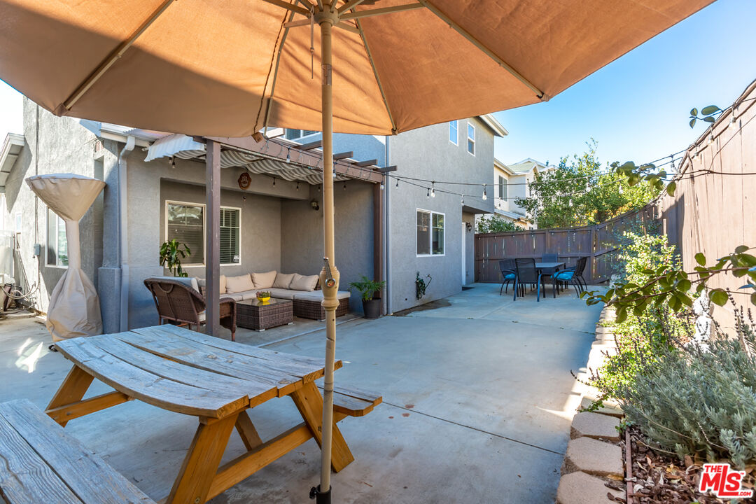 12248 Willowbend Lane Sylmar, CA 91342 - Photo 45 of 52 a view of a patio with table and chairs under an umbrella