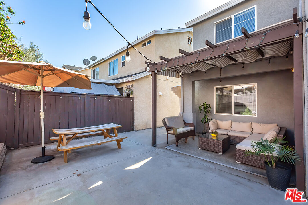 12248 Willowbend Lane Sylmar, CA 91342 - Photo 47 of 52 a backyard of a house with barbeque oven table and chairs