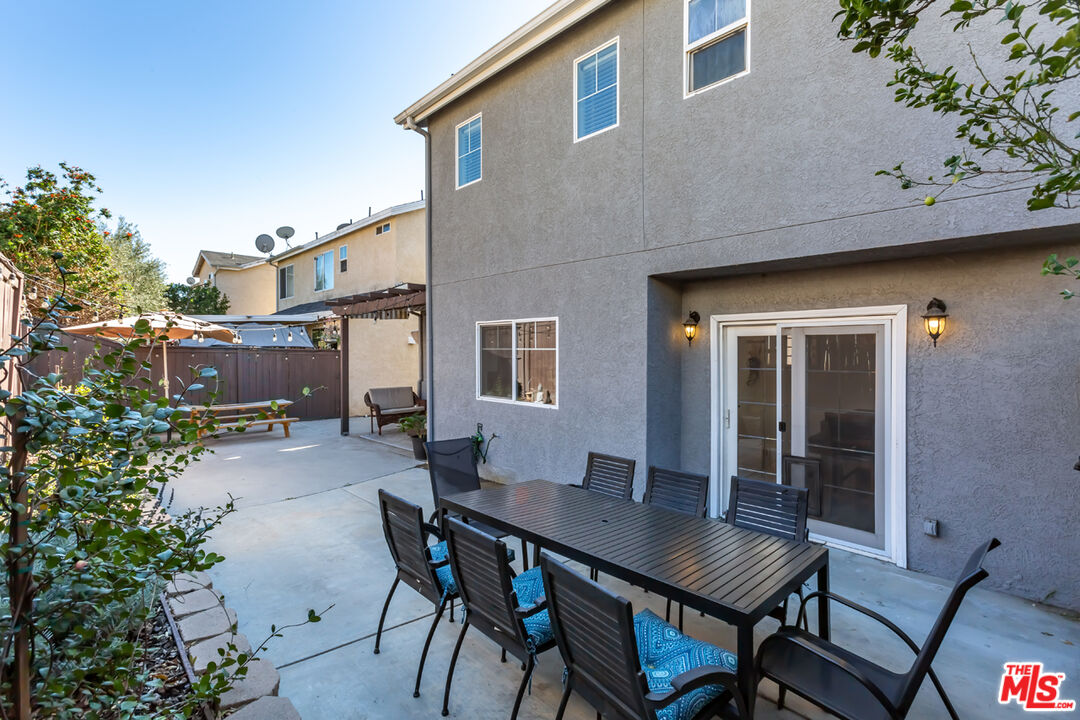 12248 Willowbend Lane Sylmar, CA 91342 - Photo 50 of 52 a backyard of a house with table and chairs