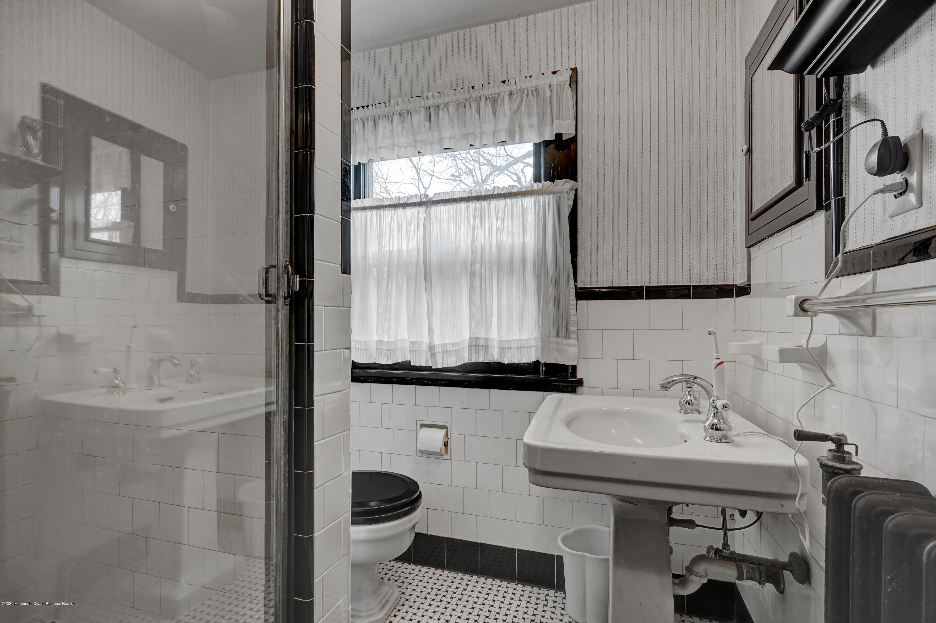 511 Wildwood Road West Allenhurst, NJ 07711 - Photo 14 of 39 a bathroom with a sink a toilet and shower