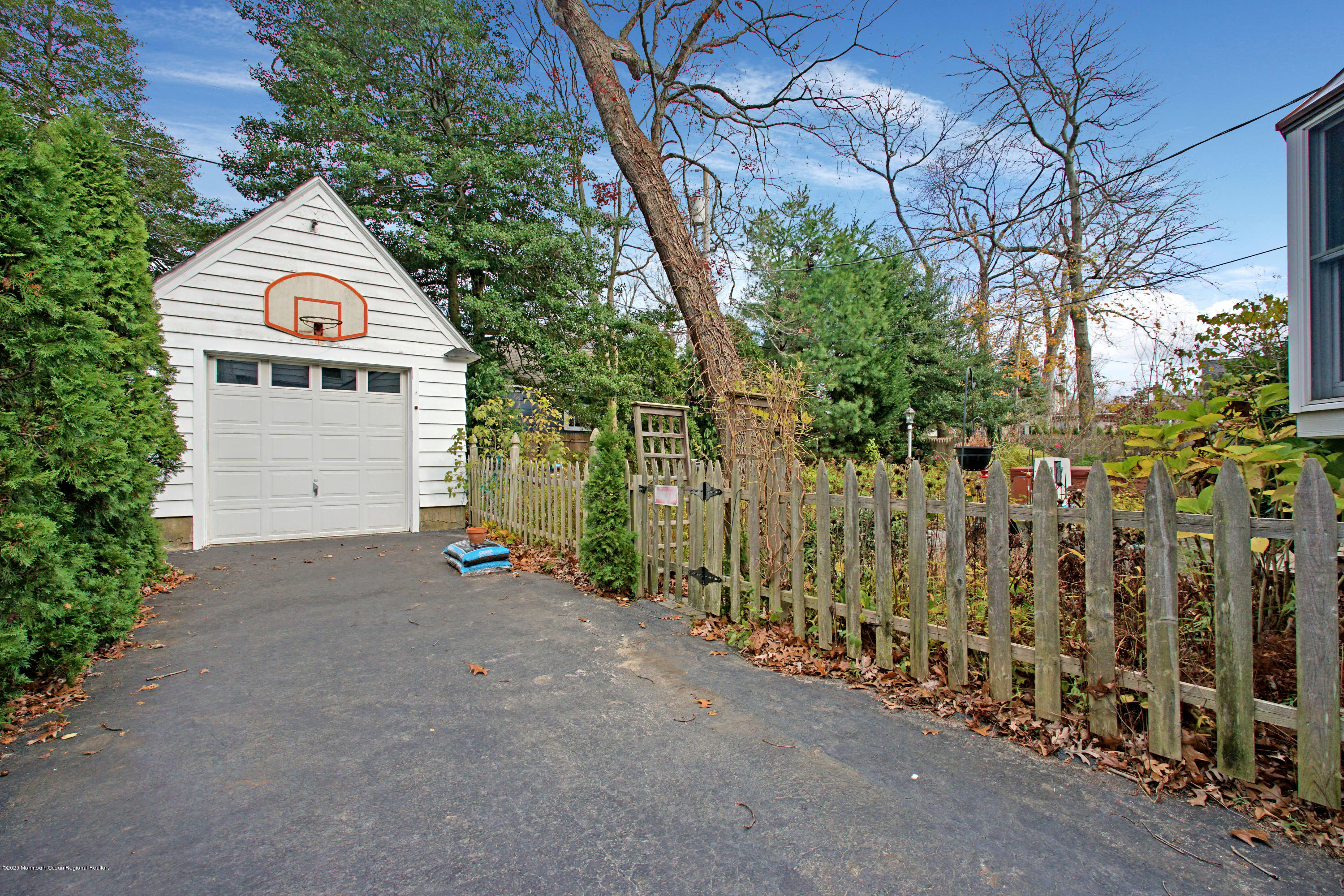511 Wildwood Road West Allenhurst, NJ 07711 - Photo 16 of 39 a front view of a house with a yard and garage