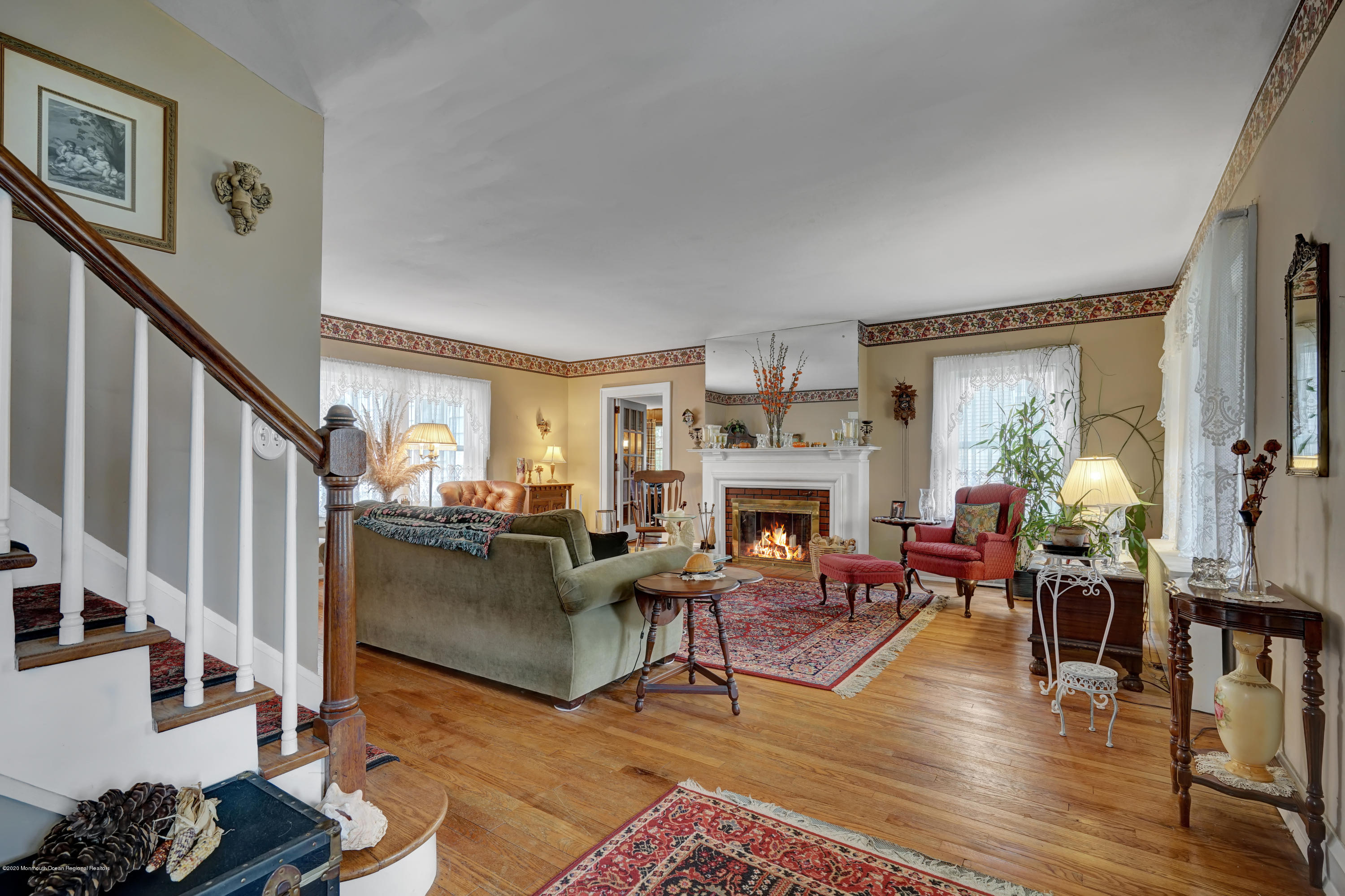511 Wildwood Road West Allenhurst, NJ 07711 - Photo 20 of 39 a living room with furniture a fireplace and a flat screen tv