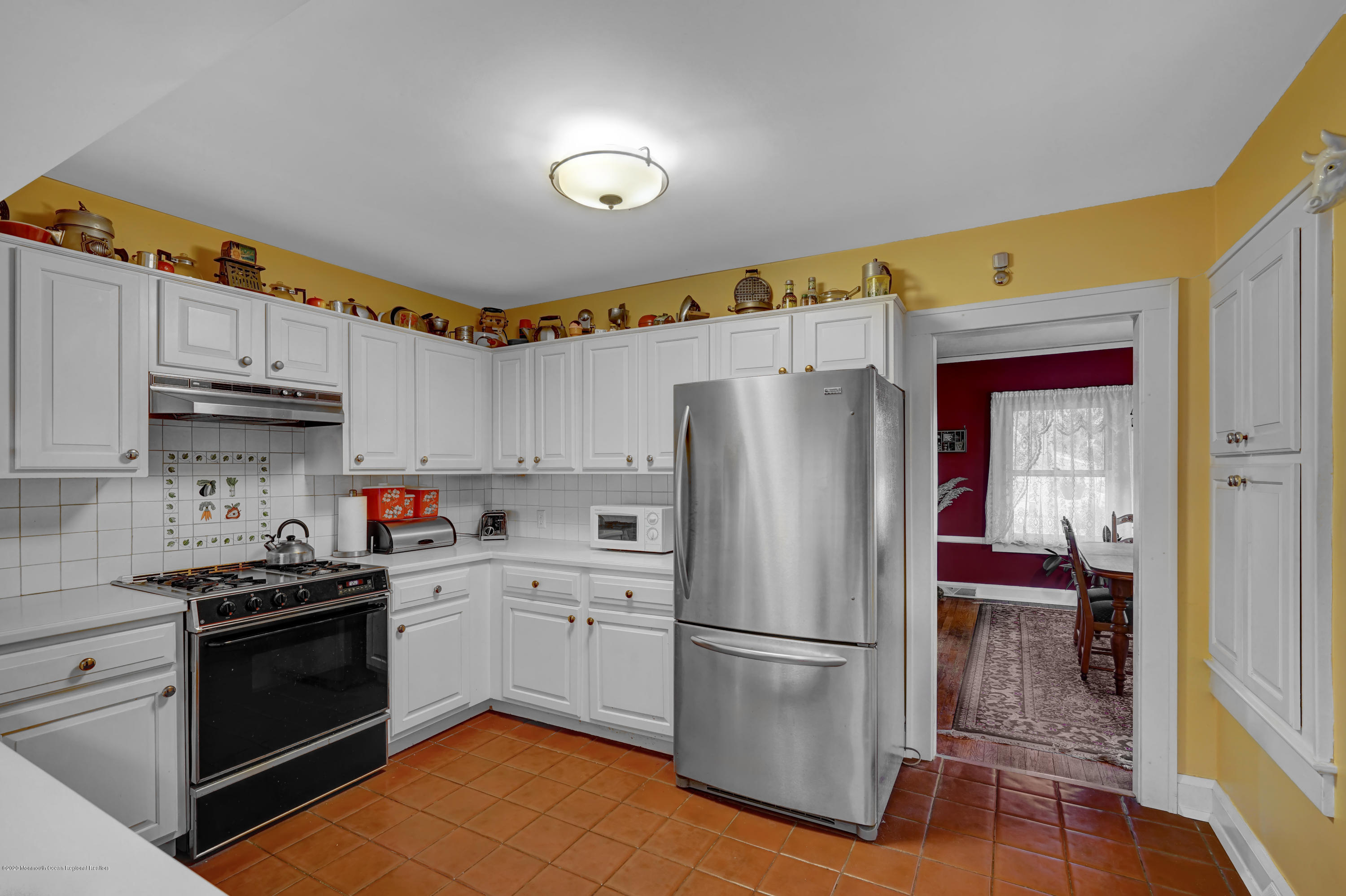511 Wildwood Road West Allenhurst, NJ 07711 - Photo 26 of 39 a kitchen with a sink a refrigerator and cabinets