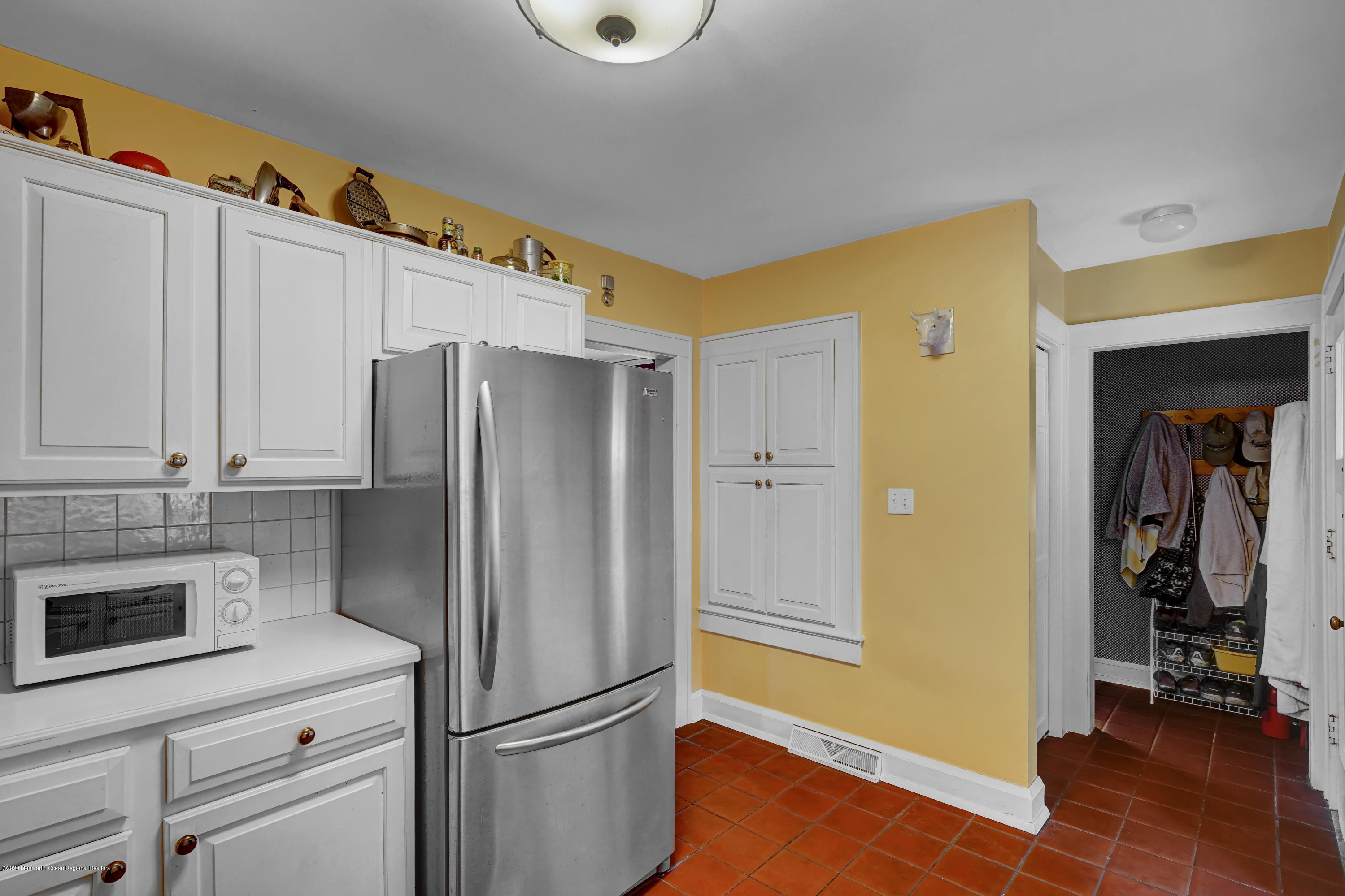 511 Wildwood Road West Allenhurst, NJ 07711 - Photo 27 of 39 a kitchen with a refrigerator and a stove top oven