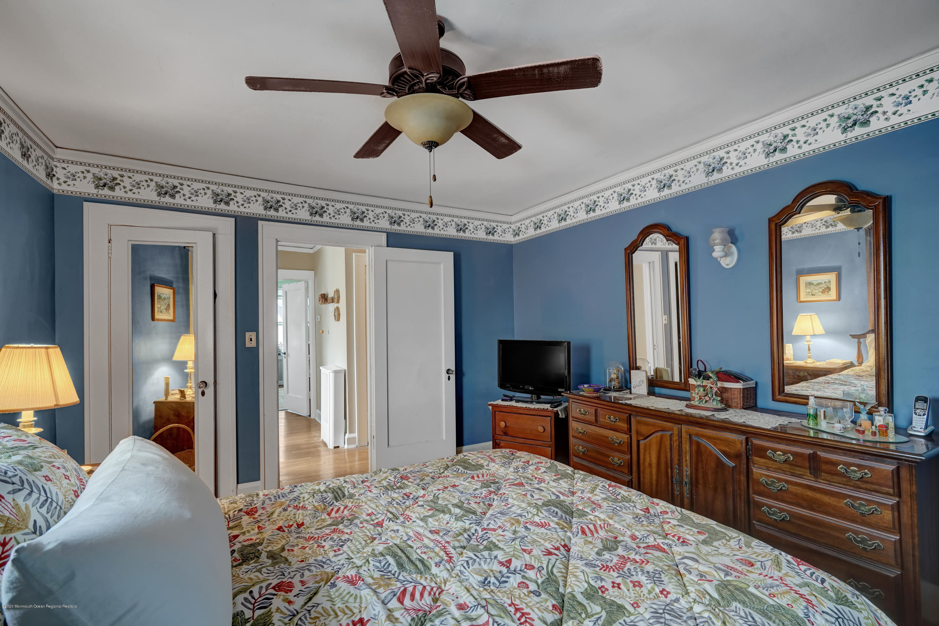 511 Wildwood Road West Allenhurst, NJ 07711 - Photo 30 of 39 a bedroom with a bed and a chandelier