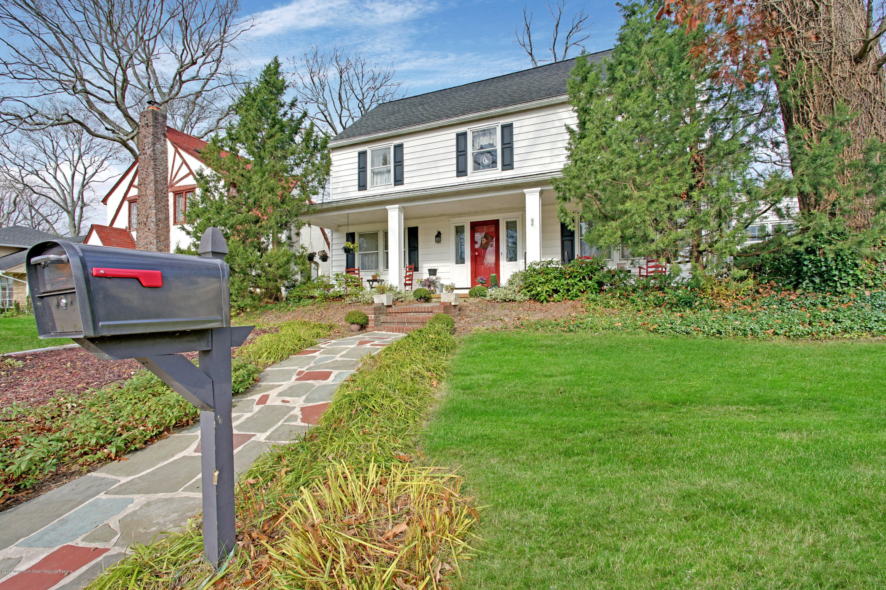 511 Wildwood Road West Allenhurst, NJ 07711 - Photo 35 of 39 a front view of a house with a yard table and chairs