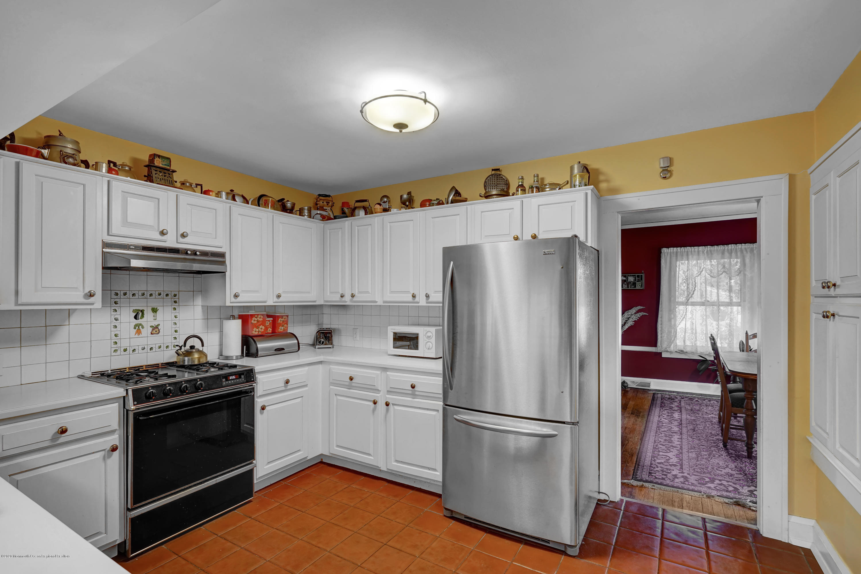 511 Wildwood Road West Allenhurst, NJ 07711 - Photo 5 of 39 a kitchen with a sink a refrigerator and cabinets