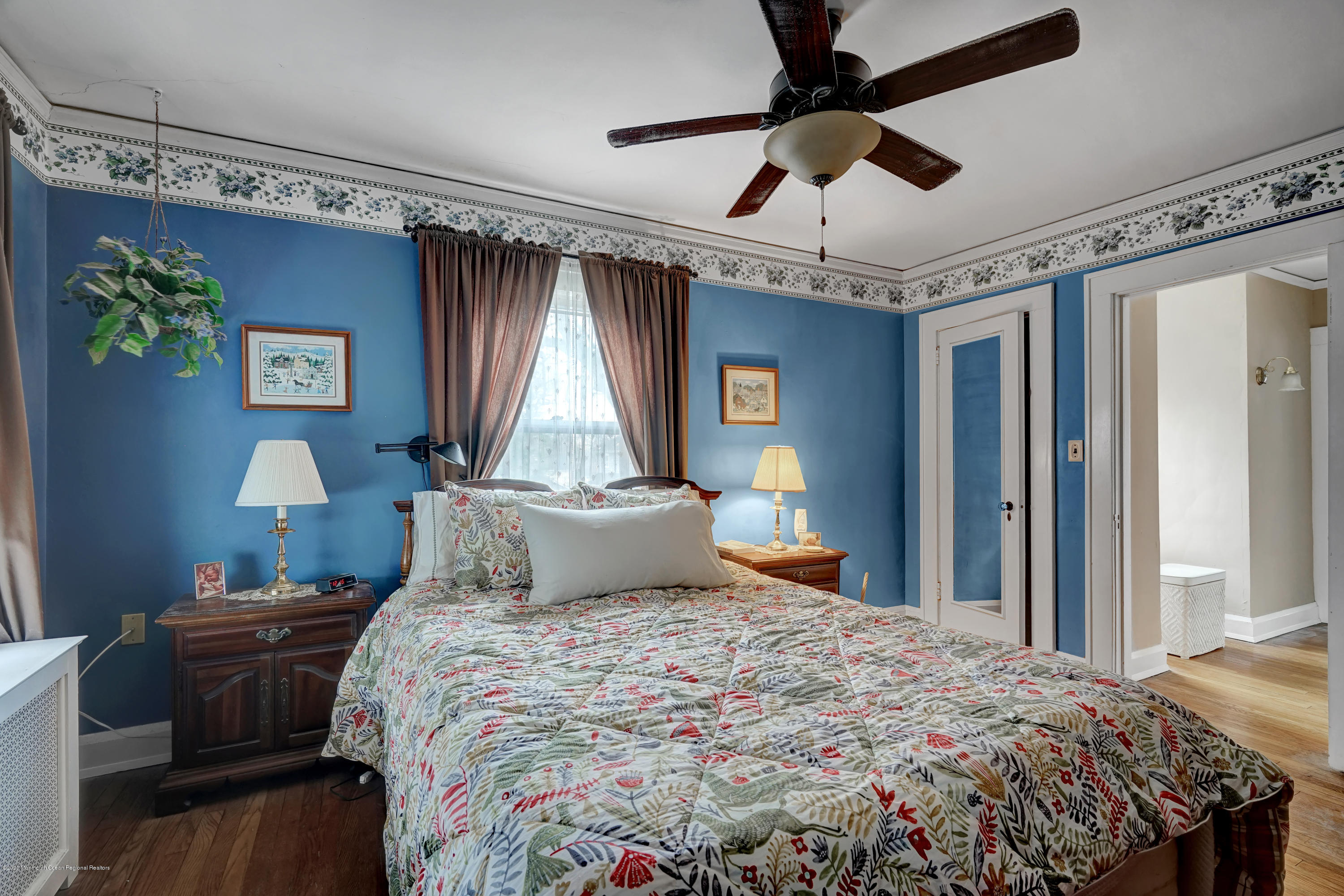 511 Wildwood Road West Allenhurst, NJ 07711 - Photo 8 of 39 a bedroom with a bed and a chandelier