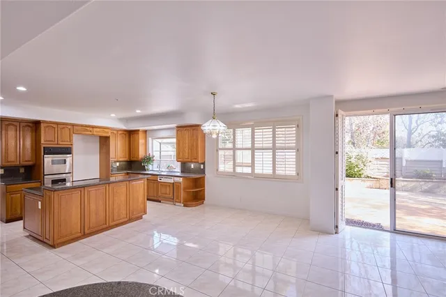 a large kitchen with a large counter top appliances and cabinets