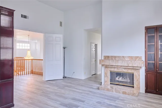 a view of a livingroom with wooden floor and a fireplace